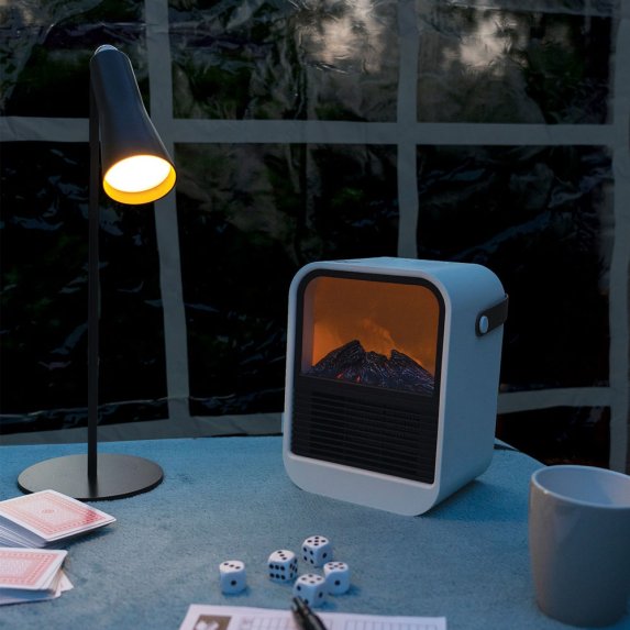 Keramisk varmebl�ser med flammeeffekt p� et bord ved siden af en lampe og et krus.